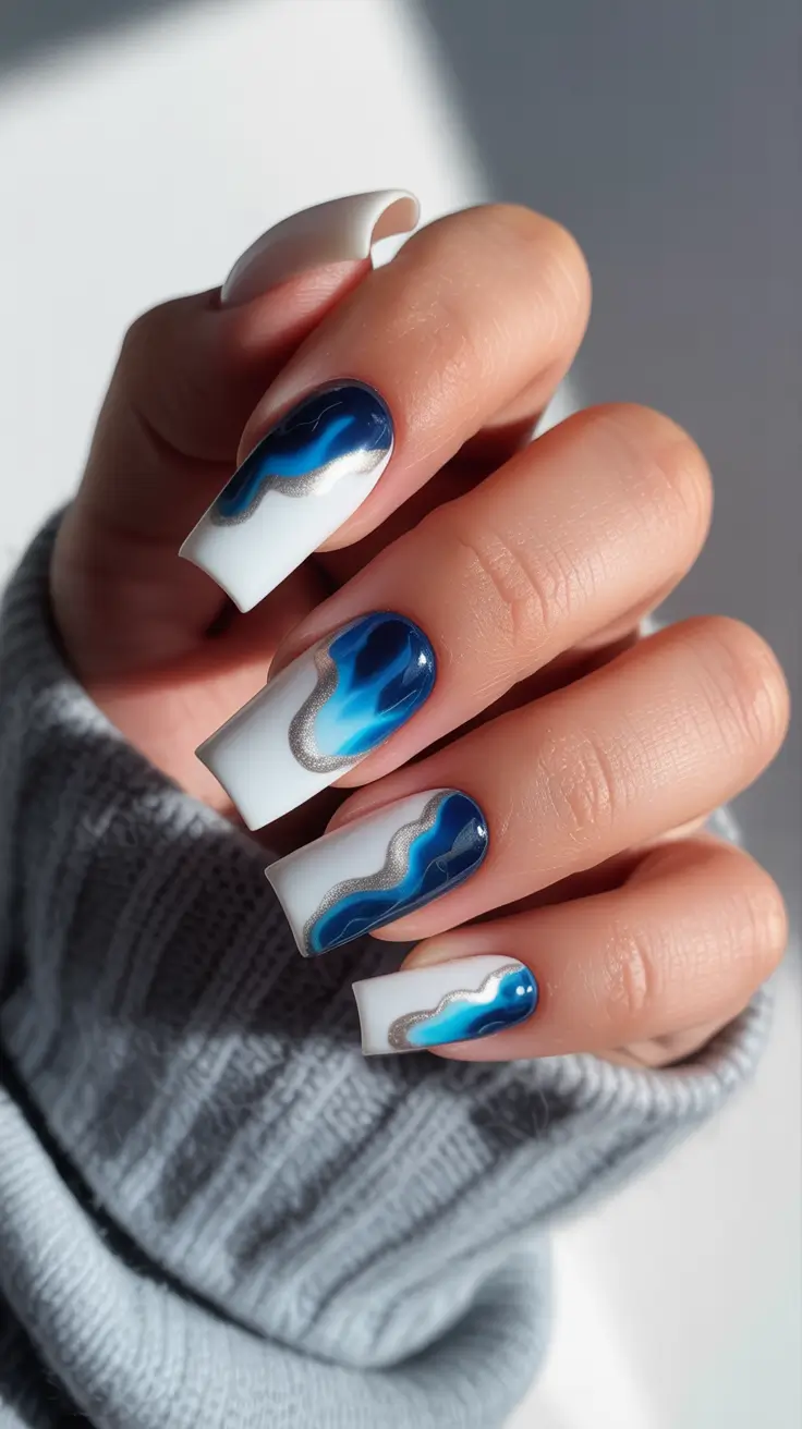 light blue nails White Base With Bold Navy and Blue Waves