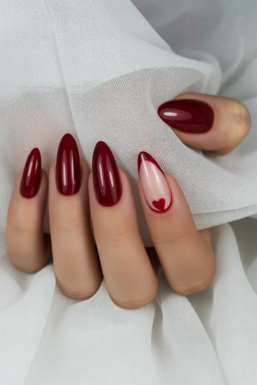 red nails Deep Red Almond Nails With a Minimal Heart Accent