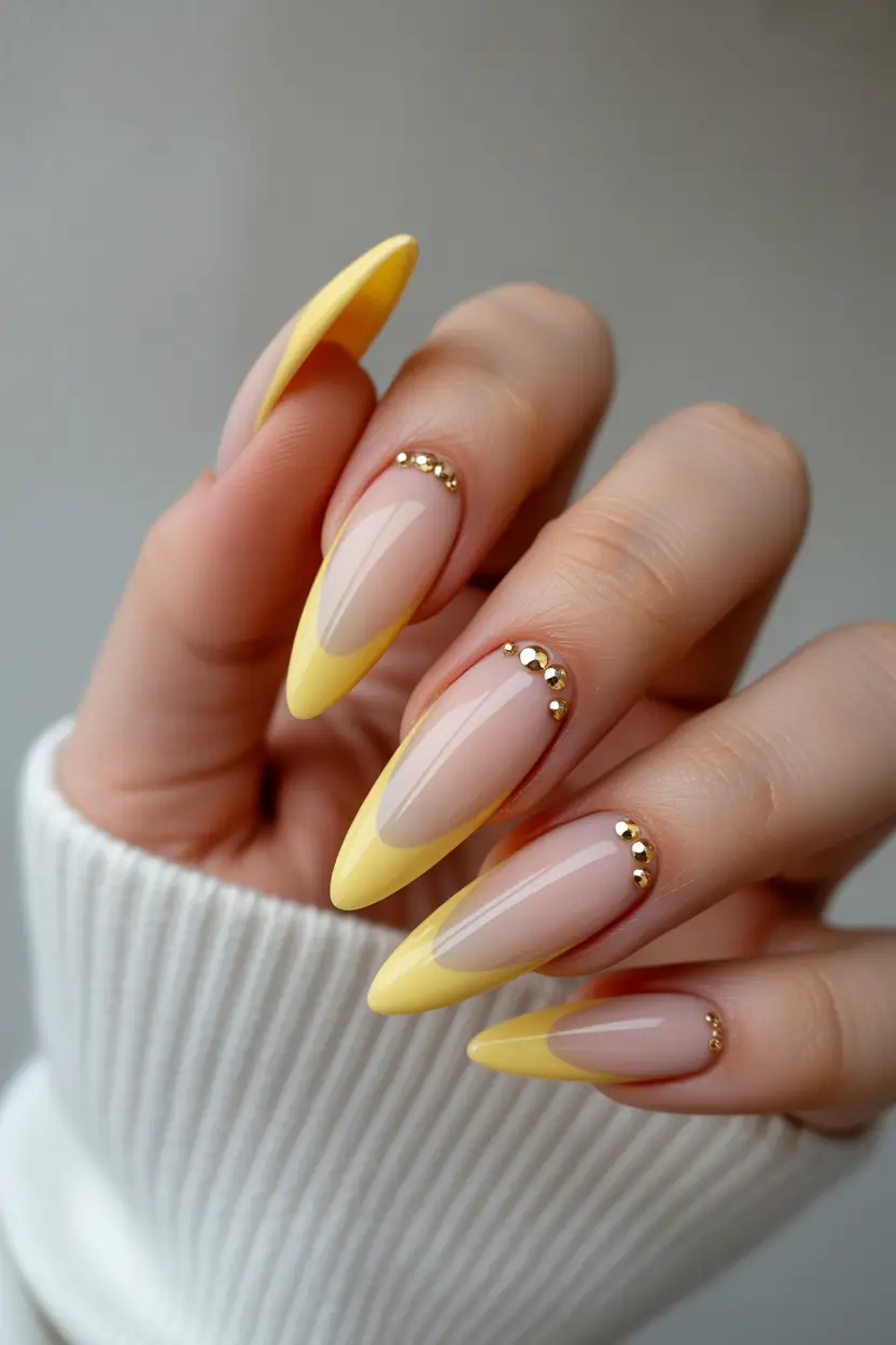 yellow nails Soft Yellow French Tips With Gold Stud Accents