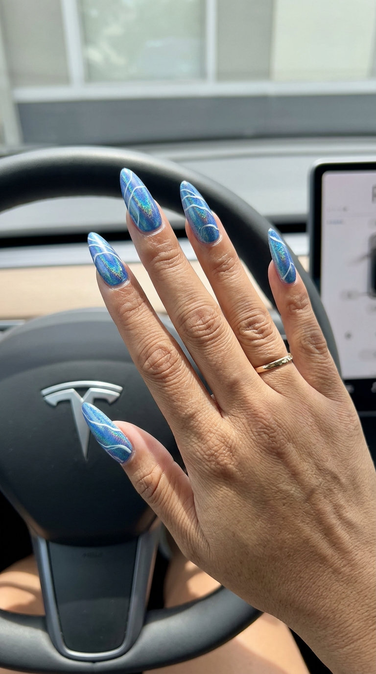 Galactic Ocean Swirls nails: futuristic holographic blue/green shift with white abstract swirls for fun summer nails 2026.