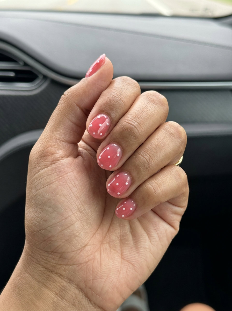 Sheer pink jelly nails with white dots. June manicure ideas - summer trends 2026.