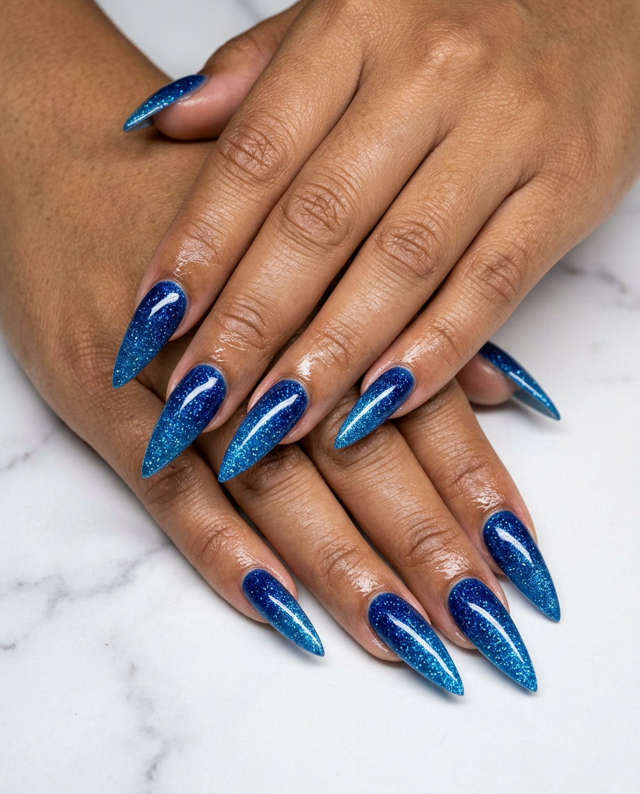 Ocean blue glitter gradient stiletto nails for summer glitter nails 2026. Sultry, edgy night out look.